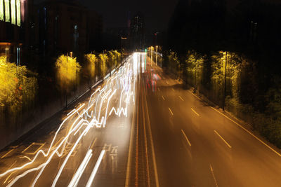 High angle view of light trails on road in city at night