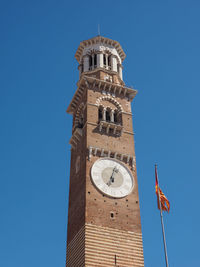 Low angle view of clock tower against clear blue sky