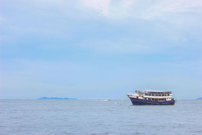 Boat sailing on sea against sky