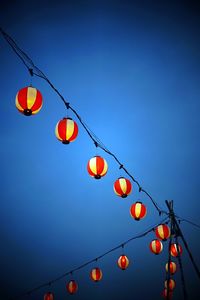 Low angle view of multi colored lanterns hanging on roof