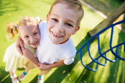 Portrait of cute sibling standing outdoors