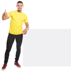 Portrait of young man standing against white background