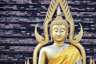 Statue of buddha against building