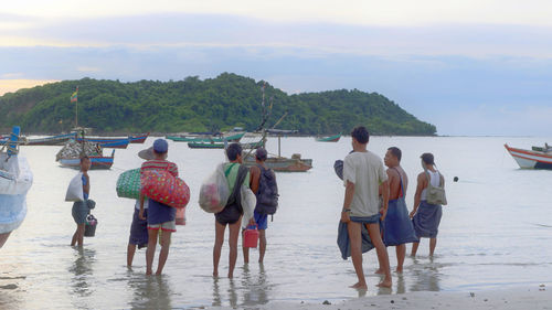 Rear view of people on beach