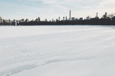 Scenic view of city against sky during winter