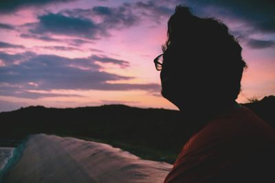 Silhouette man against sky during sunset