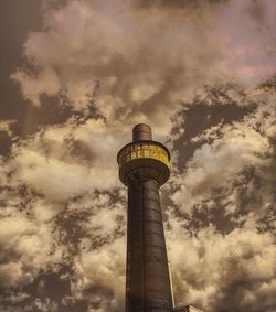 Low angle view of tower against cloudy sky