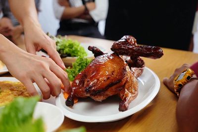 Close-up of hand holding food on table