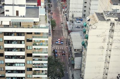 High angle view of cars on road amidst residential buildings