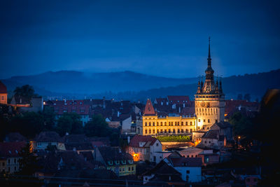 Illuminated church in city at dusk