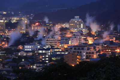 High angle view of illuminated buildings in city at night