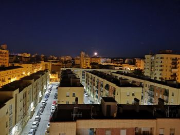 High angle view of illuminated buildings in city at night