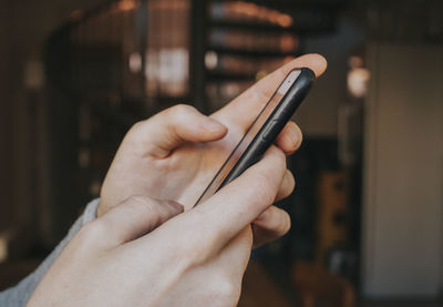 Midsection of man using mobile phone