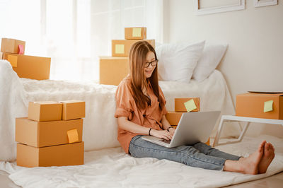 Young woman using mobile phone at home