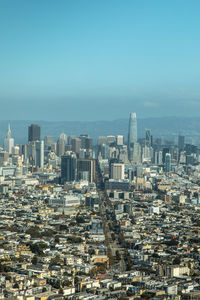 Aerial view of buildings in city against clear sky