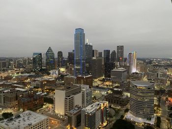 Illuminated cityscape against sky