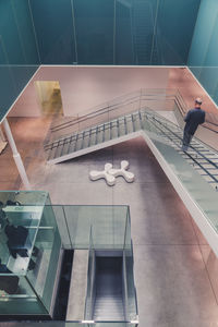 High angle view of man walking on staircase