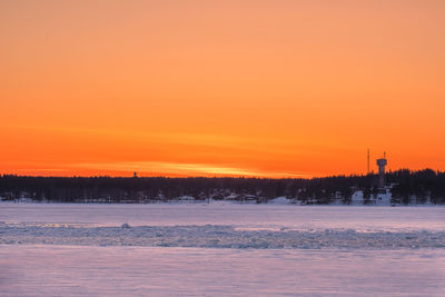 Scenic view of frozen lake against romantic sky at sunset