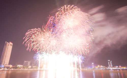 Low angle view of firework display at night