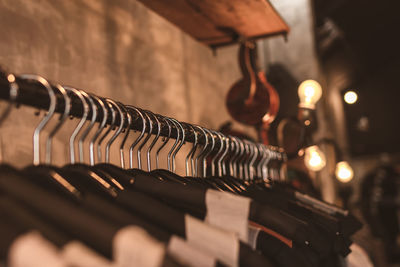 Close-up of coathangers hanging on rack