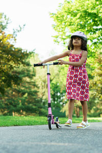 Portrait of young woman standing on road