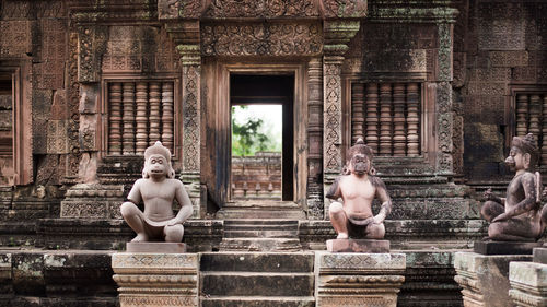 Statue of buddha against building