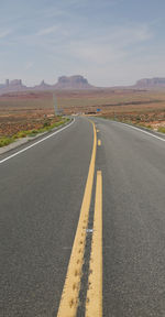 Surface level of empty road against sky