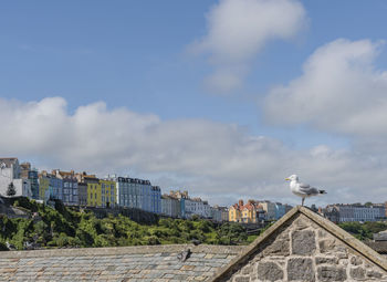 Buildings in city against cloudy sky