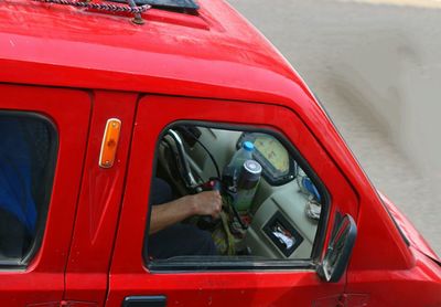 Cropped hand of man driving car