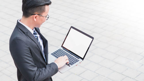 Man using laptop on mobile phone