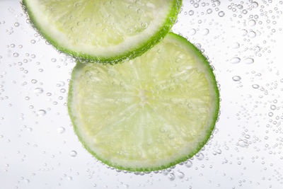 Close-up of lemon slices on white background