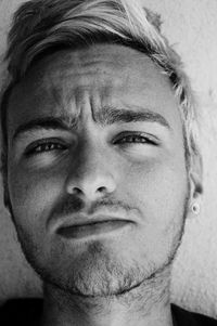 Close-up portrait of young man with spiky dyed hair