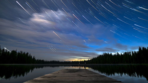 Scenic view of lake against sky at night