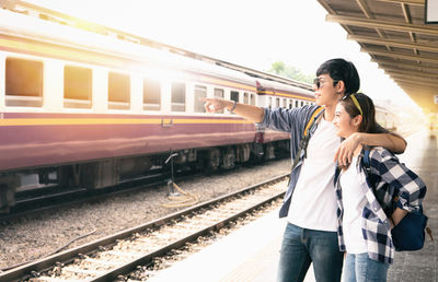 Full length of woman standing on railroad platform