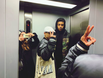 Full length portrait of young man with reflection in mirror