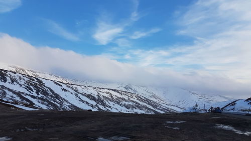 Scenic view of snowcapped mountains against sky