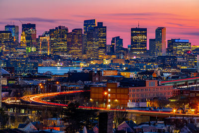 High angle view of city lit up at night