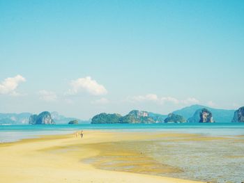 Scenic view of beach against blue sky