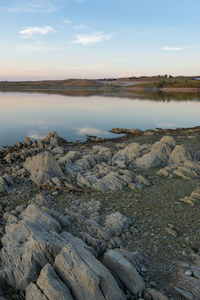 Lucefecit dam in terena with reflection on the lake reservoir and rocks, in portugal