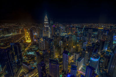 High angle view of city lit up at night