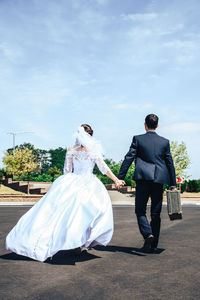 Rear view of a couple walking together