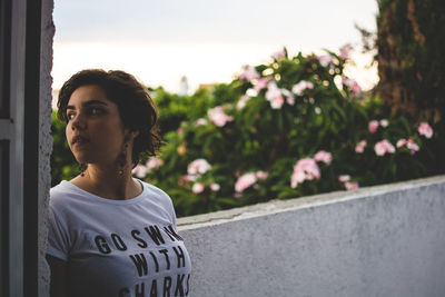 Close-up portrait of young woman standing outdoors