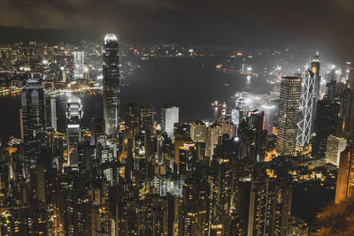 Illuminated cityscape against sky at night