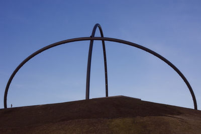 Low angle view of metallic structure against clear sky