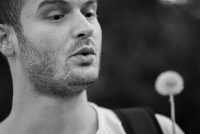 Close-up portrait of young man looking away