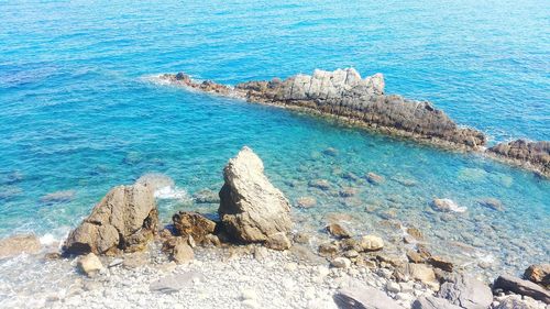 High angle view of rocks by sea