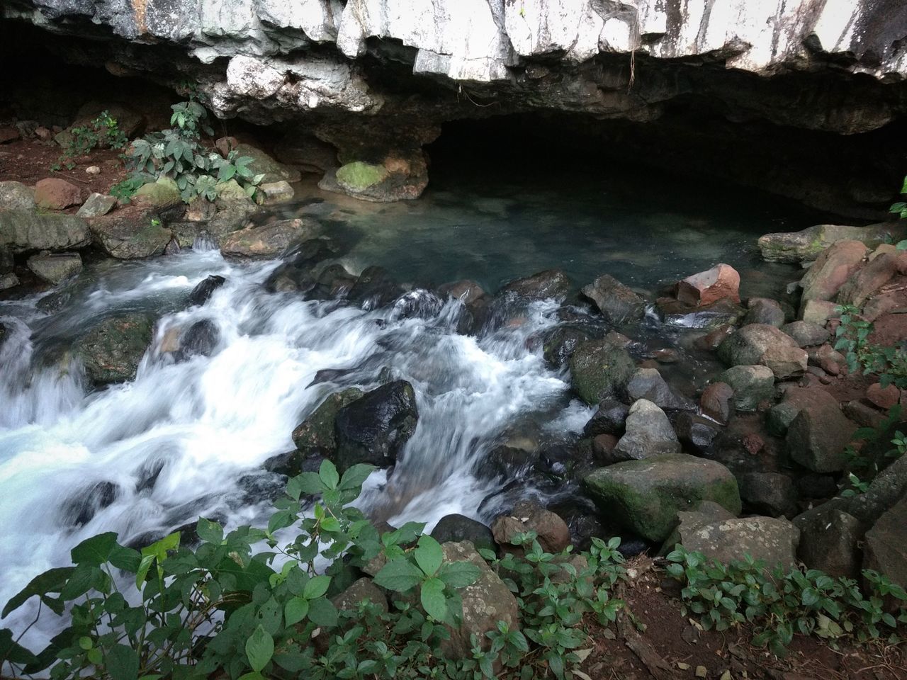 STREAM FLOWING THROUGH ROCKS