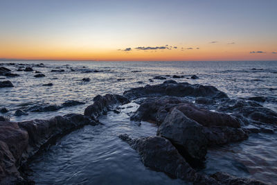 Scenic view of sea against sky during sunset