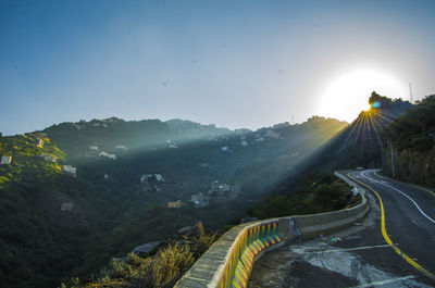 Panoramic view of road by mountains against sky