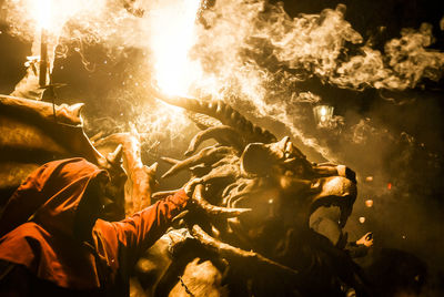 People wearing masks at dragon festival during night